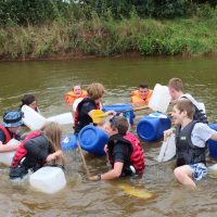 Young people raft building in the water