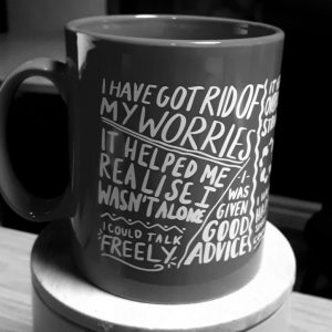 A mug covered with affirming quotes - I have got rid of my worries, it helped me realise I wasn't alone, I could talk freely, I was given good advice