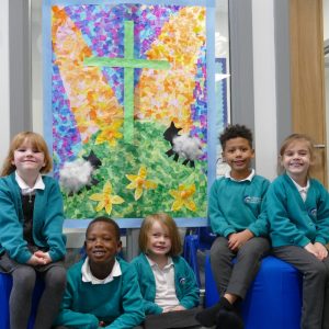 Children from Clearwater Primary Academy sit with their Easter collage