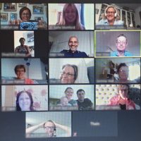A Zoom screen with lots of friendly faces with Malc Allen at the centre