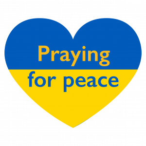 A yellow and blue heart with the words Praying for peace