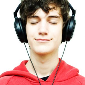 Teenager listening to large headphones