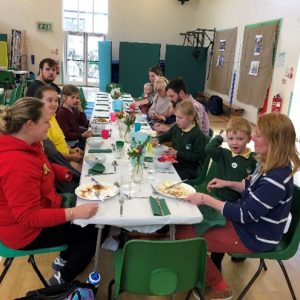 Staff and families from school eat together