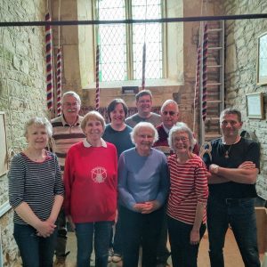 Pat Hall centre with ringers at Woolstone church