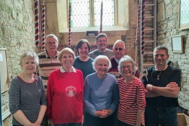 Pat Hall centre with ringers at Woolstone church