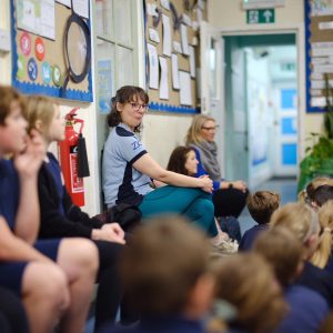Lucy Newbold, year 3 and 4 teacher and Philosophy for Children lead smiles at a child with a cheeky expression!
