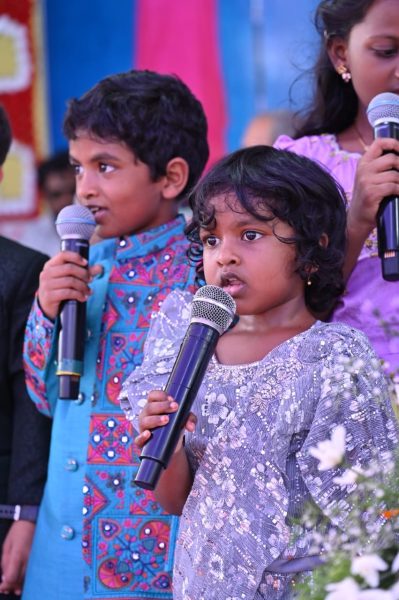Two children singing in