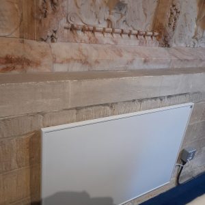 Wall panel heater behind the altar