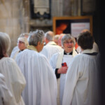 Clergy talking in south transept ahead of Chrism Eucharist