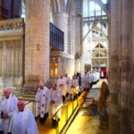Queues of clergy making their way into the Chrism service at Gloucester Cathedral