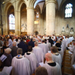 Congregation faces towards the reading of the Gospel in the centre of the nave of Gloucester Cathedral